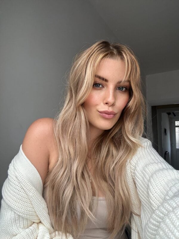 Blonde beauty UGC creator posing in soft natural light, showcasing clean makeup and natural skin for authentic beauty content creation.