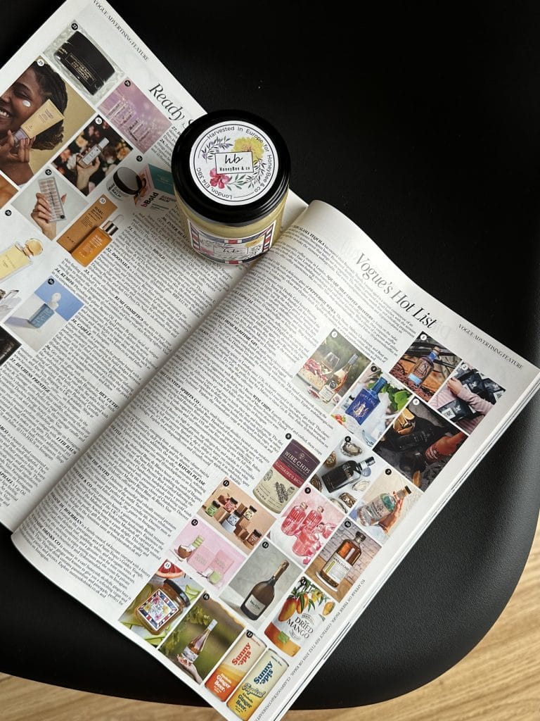 Open magazine with a honey jar placed on top, showcasing a feature article and photo collage