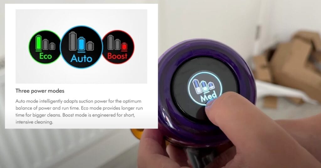 Close-up of a hand adjusting the power mode on a Dyson vacuum touchscreen, displaying “Med” mode, with an inset showing Eco, Auto, and Boost mode icons and descriptions.