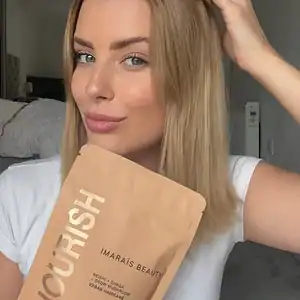 E-commerce UGC showing a content creator holding a beauty supplement product in a natural at-home setting
