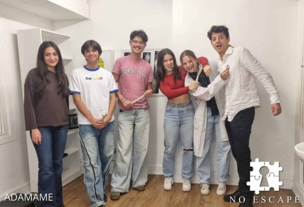 A group of friends posing in a No Escape London escape room