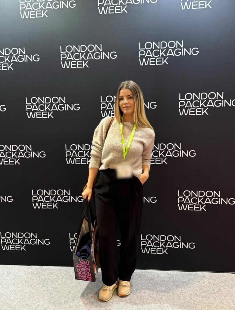 Velena Nikolova at the London Packaging Week 2025 backdrop, holding a show bag