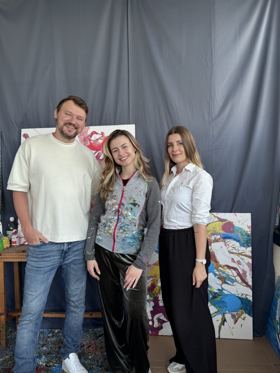 Dragos Nistor and Velena Nikolova with Silvi the artist in her studio with paintings behind