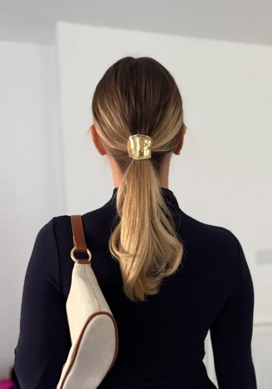 UGC tutorial content showing woman from behind with styled ponytail and hair accessory